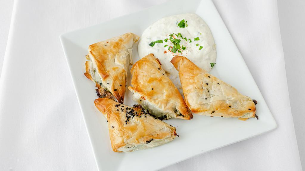Spanikopita · Phyllo dough layered with a Lebanese spinach and feta mix. Served with tzatziki.