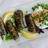Meat Stuffed Grape Leaves · Ground beef, rice, tomatoes, and spices rolled into dolmas. Served with tzatziki. GF
