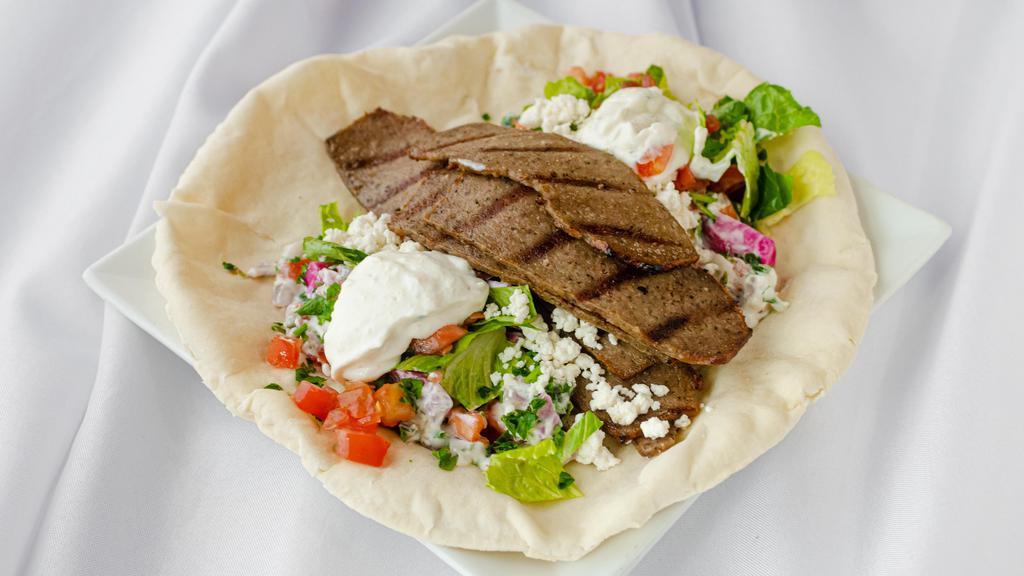 Lamb Gyro Wrap · Classic Greek style lamb gyro. Made with feta cheese and tzatziki. Each wrap is loaded with lettuce, onions, tomatoes, pickled turnips, and parsley.