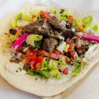 Shawarma Wrap · Chicken, Lamb, or Beef
Thinly sliced meat marinated in onions and spices. Made with tahini. ...