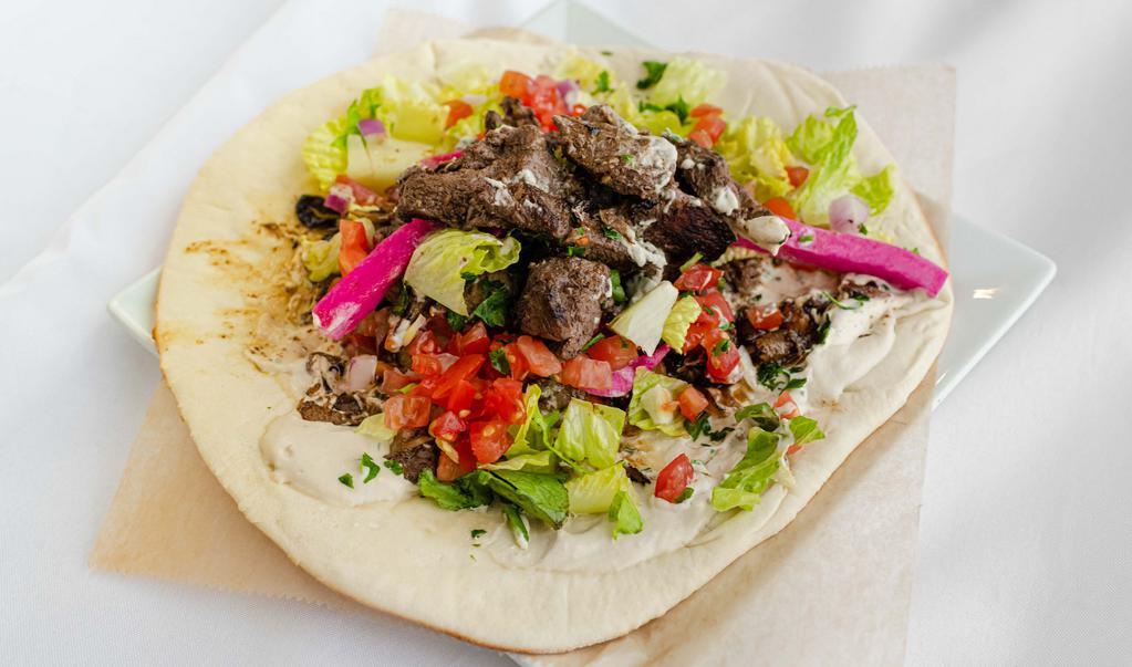 Shawarma Wrap · Chicken, Lamb, or Beef
Thinly sliced meat marinated in onions and spices. Made with tahini. Each wrap is loaded with lettuce, onions, tomatoes, pickled turnips, and parsley.
