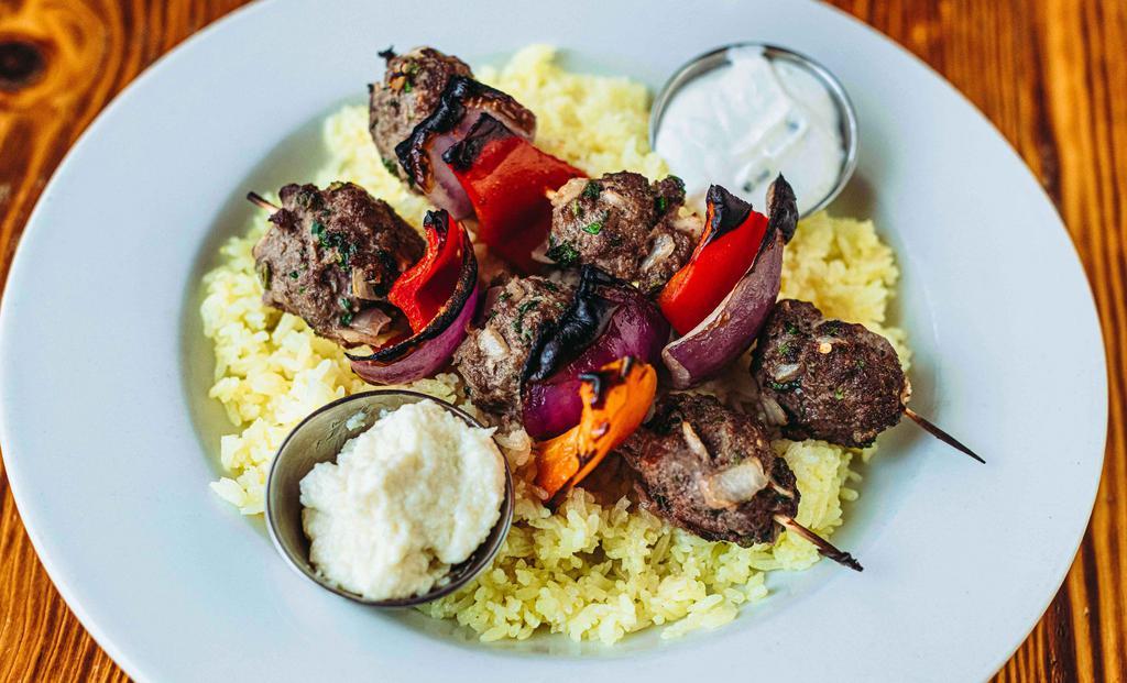 Beef Kafta Kabobs Plate · Ground beef mixed with parsley, onions, and spices. Kabob plates are served with two skewers over saffron jasmine rice. Served with tzatziki and toum. GF