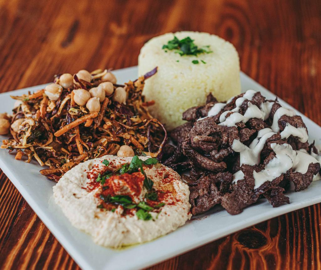 Shawarma Plate · Chicken, Lamb or Beef 
Thinly sliced meat marinated in onions and Lebanese spices. Served with hummus, cabbage kale garbanzo salad, and saffron jasmine rice. GF