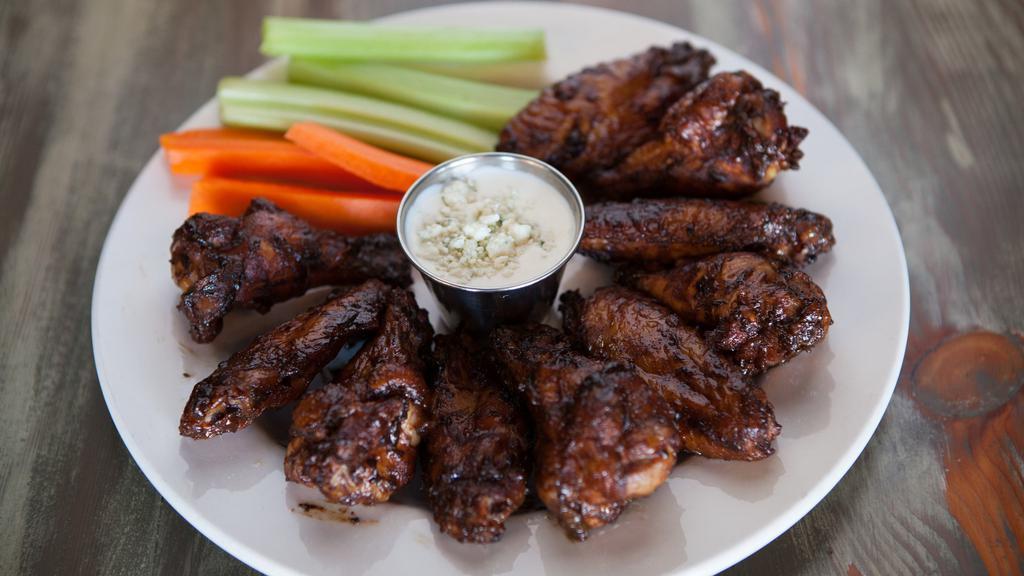 Smoked Wings · Gluten-free. Large cherry wood smoked wings coated with our own blend of spices, then smoked, served with house-made ranch or blue cheese, served with carrot and celery sticks.