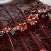 Our Signature Style Ribs · Our pork spare ribs are slow smoked to create a perfectly balanced smoky taste. Served with ...