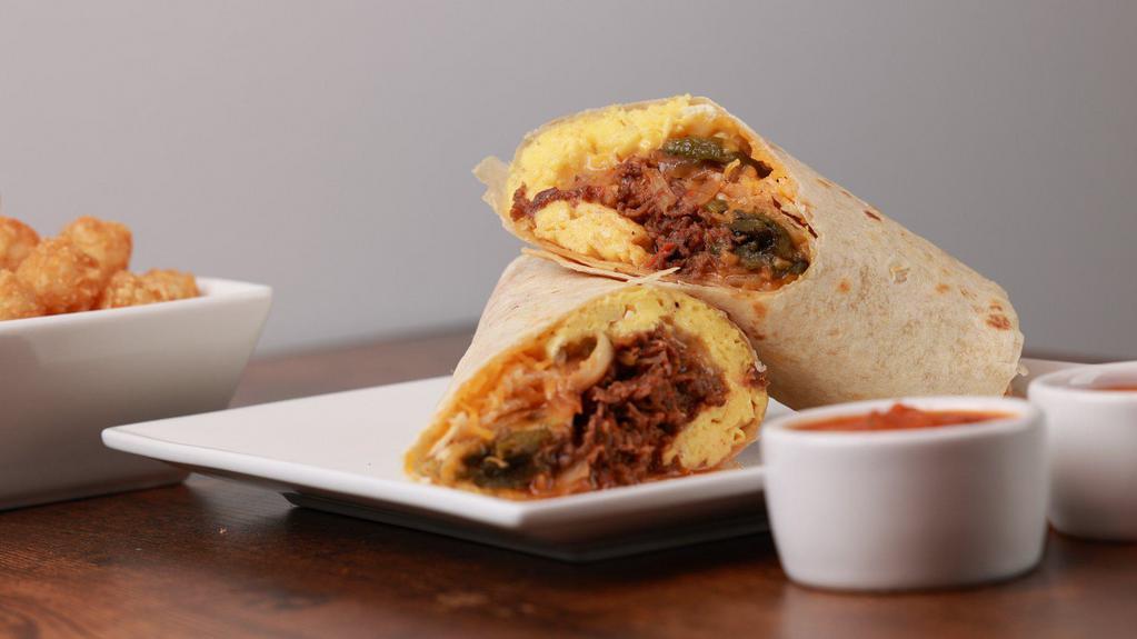 Steak & Eggs · Scrambled eggs, ribeye steak, sauteed onions, poblano peppers, mushrooms with a spicy salsa and melted shredded cheese rolled in a flour tortilla wrap. Served with Cholula hot sauce.