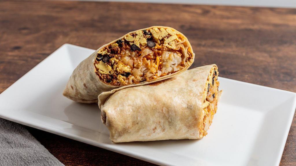 Kick Starter  · Eggs, chipotle cream cheese, chorizo, black beans, crispy tater tots and melted shredded cheese rolled in a flour tortilla wrap. Served with hot sauce.