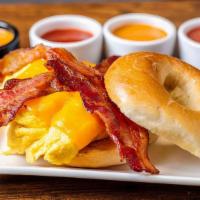 Breakfast Bagel Express · Scrambled eggs, bacon, melted cheddar cheese on toasted plain bagel.