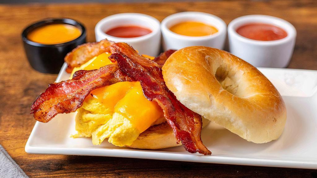 Breakfast Bagel Express · Scrambled eggs, bacon, melted cheddar cheese on toasted plain bagel.