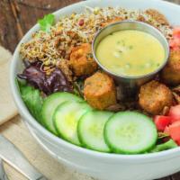 Falafel Salad · Diced tomato, cucumbers, flax seed cracker crumbles and house sprouts on a bed of organic gr...