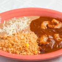 Camarones A La Diabla · Large shrimp sautéed with garlic spices and covered with a spicy red hot sauce served with r...