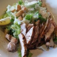 Entree Caesar Salad · Chopped romaine hearts, garlic Caesar dressing, croutons and shaved parmesan.