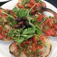 Bruschetta · Sliced bread topped with cherry tomatoes, basil, oregano, olive oil, served with arugula and...