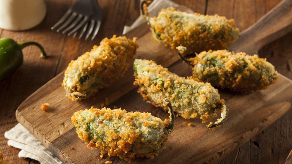 Jalapeño Poppers (4 Pcs) · Spicy jalapeños stuffed with cheese, lightly breaded and fried until crisp and golden on the outside and melty on the inside.