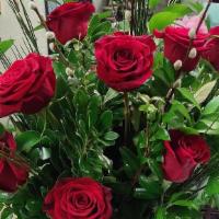 Showy Dozen Red Roses · One dozen red roses in a nice container and premium greenery!  Perfect for that special some...