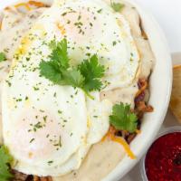 Hillbilly Skillet · A mound of breakfast potatoes, ham, sausage, bacon, cheese, your choice of eggs and smothere...