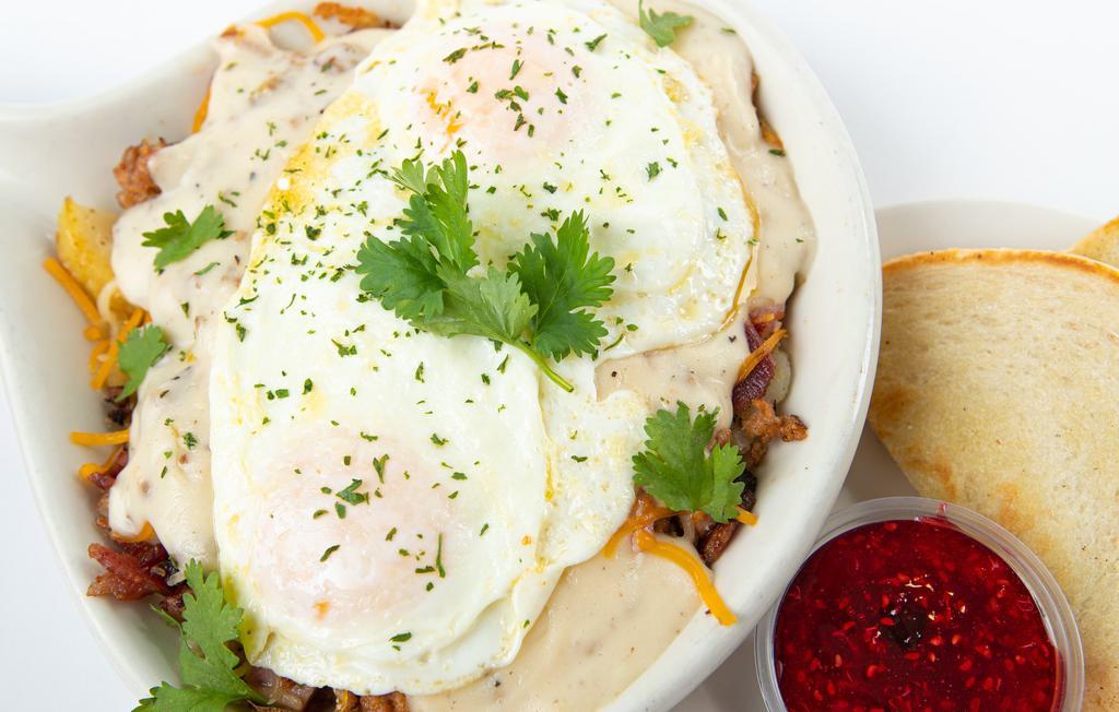 Hillbilly Skillet · A mound of breakfast potatoes, ham, sausage, bacon, cheese, your choice of eggs and smothered in your choice of country gravy or chile verde and served with white or wheat toast.