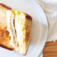 Breakfast Sandwich · Scrambled eggs, American and Swiss, choice of bacon, ham or sausage.