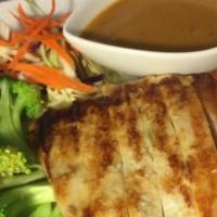 Lemongrass Chicken · Grilled chicken breast marinated in lemon grass sauce and topped with peanut sauce on a bed ...