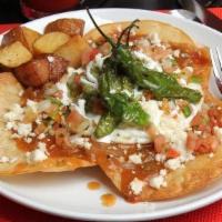 Huevos Rancheros · 3 crispy corn tortillas • pork green chili • 3 eggs OM sour cream • ranchero cheese • guacam...