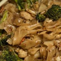 Pad See Ew · Pan-fried flat rice noodles with your choice of meat, broccoli, carrots and egg in a black s...