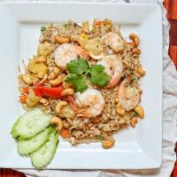 Pineapple Fried Rice · Rice stir fried with your choice of meat, egg, tomatoes, peas, carrots, onions, pineapple an...