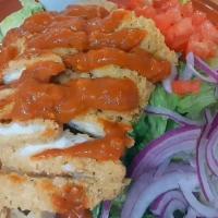 Buffalo Chicken Salad · Romaine lettuce topped with tomato, red onion, and crispy chicken. Drizzled with your choice...