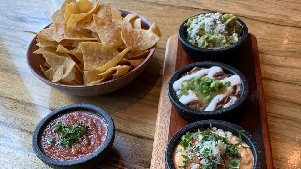 Dip Flight · All of our favorite dips! Creamy three cheese queso, fresh guacamole, and hearty black bean queso served with house chips and salsa.