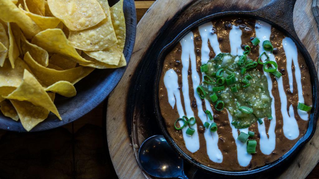 Black Bean Dip · Black beans, habanero, garlic crema, tomatillo salsa and green onion. Gluten-free, vegetarian.