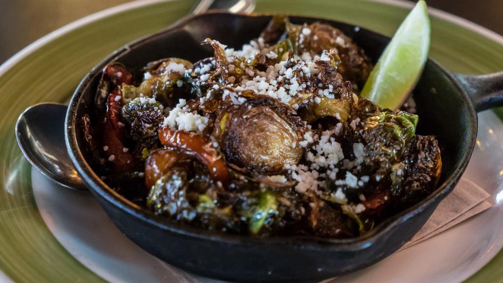 Crispy Brussels Sprouts · Fried brussels sprouts, peppers & onions, lime, agave, cotija