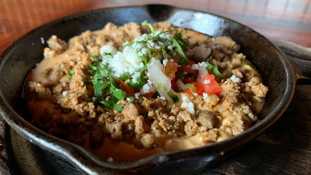 Queso Con Chorizo · Melted three-cheese house blend, creamy habanero sauce,
pico de gallo, cilantro, queso fresco