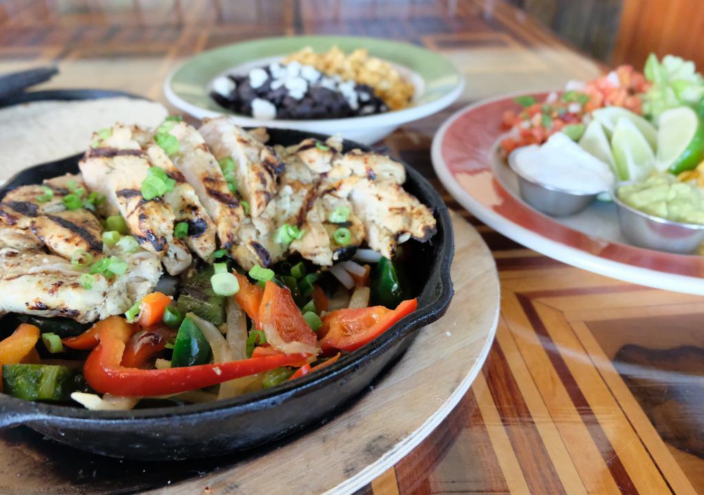 Fajita-Style For Two (Pick One) · Four large tortillas per person (choice of corn or flour), lettuce, jack and cheddar cheeses, pico de gallo, guacamole, cilantro-lime sour cream, sautéed onions and peppers.                                                               
Consuming raw or undercooked food items may increase your chance of food-borne illness.