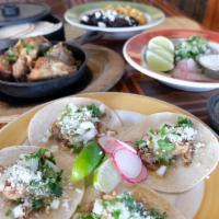 Street Tacos For Four (Pick Two): · Four small corn tortillas per person, tomatillo salsa, cotija, onion, cilantro, lime.       ...