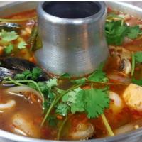 Tom Yum Seafood · Seafood, Thai hot sour soup with mushrooms, lemon grass, galangal, tomatoes, onions, cilantr...