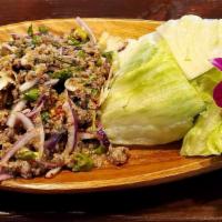 Larb Beef · Ground beef, green onions, cilantro, onions, kaffir leaves served with green leaf and ice le...