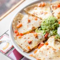 Quesadilla · Soft flour tortilla stuffed with melted cheese, onion and tomato. Served with sour cream and...