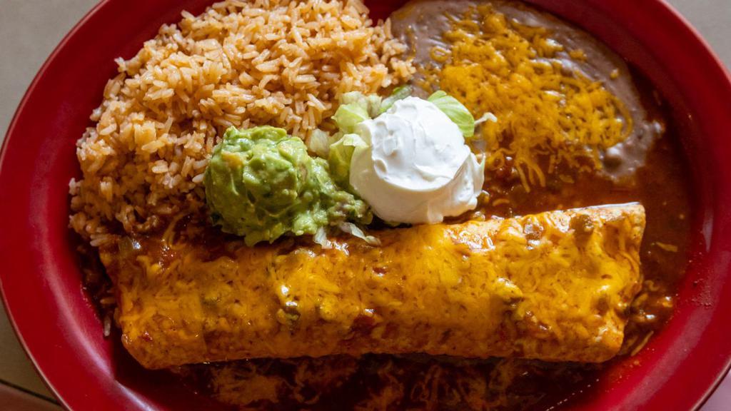 Burrito Carnitas · Choice of chicken, steak or pork. Wrapped in a flour tortilla served with green pepper, onions, burrito sauce, melted cheese, sour cream and guacamole.