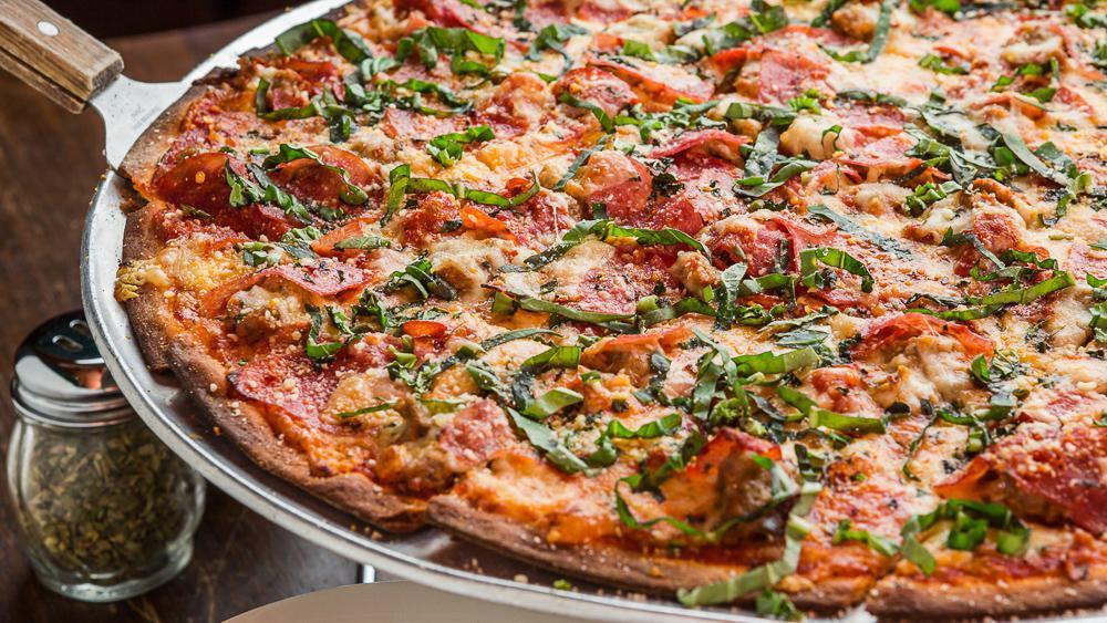 Clark Street Meat Pizza · It's the spicy meat pizza that keeps on giving.It's loaded with our Chicago sausage, capicola, garlic, oregano, chili flakes, Wisconsin, Parmesan and Parmano cheeses, then finished with fresh basil.
