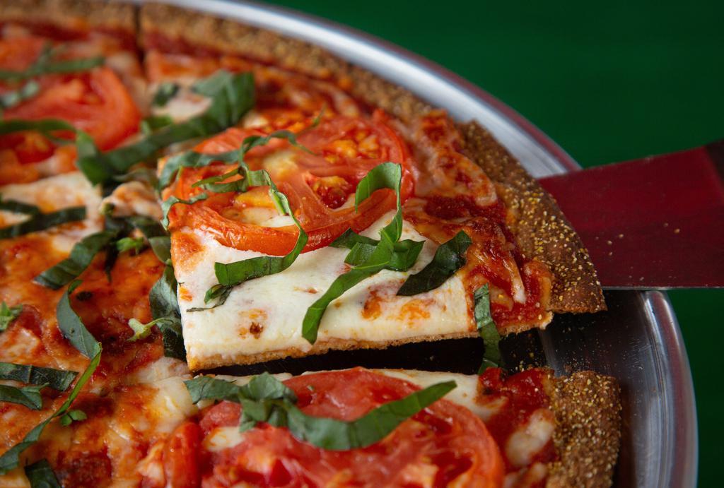 Aunt Margherita Pizza · If the Queen of Savoy would eat this pizza then it's good enough for your aunt. Our signature thin crust is lightly sauced and topped with fresh mozzarella, fresh cut tomatoes and fresh thinly sliced basil. This thing is royalty.