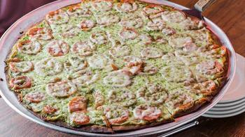 Oregano'S Own Pesto Pizza · This will wake up those snoozing taste buds! We spread basil pesto on a fresh, thin crust, then top it with ripe tomatoes and Wisconsin cheese... POW!!