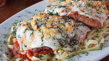 Jumbo Chicken Parm · Huge all natural chicken breast served on a bed of fettuccine and topped with our homemade m...