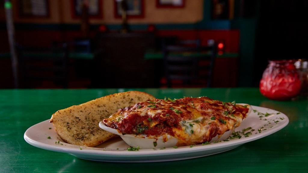 Italian Flag Lasagna · Pasta stuffed with our meat sauce, a little bit of spinach, Italian cheeses and topped with marinara, then baked to perfection. Made daily, so served until there ain't know more!