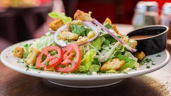 Simple House Salad · Fresh Romaine blend, red onion, sliced cucumber, sliced tomatoes, pepperoncini, homemade cro...