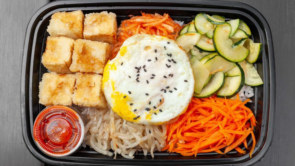 Tofu Bibimbap · Mixed vegetables(carrot, zucchini, bean sprout, radish) and fried tofu layered on white rice, special Korean spicy sauce, gochujang. Sunny side egg on top.