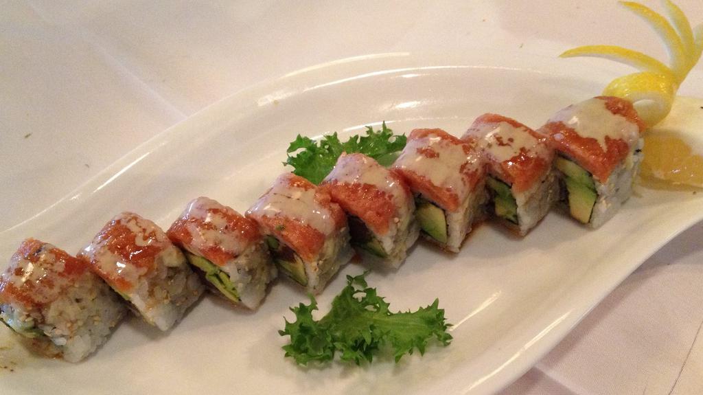 Crazy Roll · Black pepper tund with avocado topped with spicy tuna and drizzled with house signature sauce. Raw.