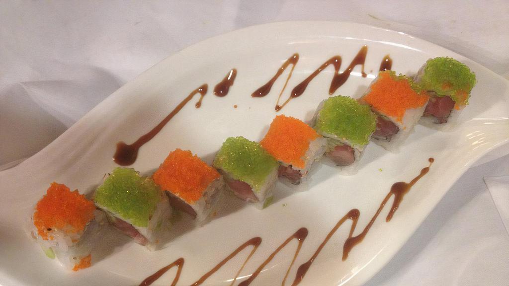 Emerald Ruby Roll · Tuna, salmon, yellowtail and cucumber inside topped with tobiko and wasabi tobiko. Raw.