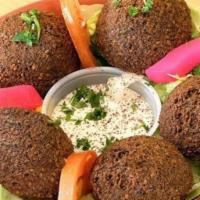 Falafel (5 Pcs) · With tahini sauce. Ground chickpeas fried with onions and parsley. (V) (GF)