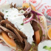 Greek Lamb Gyro · Traditional lamb and beef carved fresh, lettuce, tomatoes, onions, feta cheese and tzatziki ...