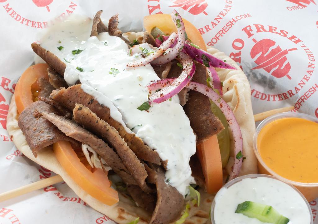 Greek Lamb Gyro · Traditional lamb and beef carved fresh, lettuce, tomatoes, onions, feta cheese and tzatziki wrapped in a Greek pita