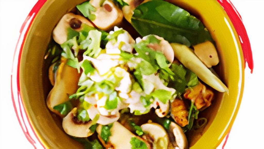Tom Yum Gai** · Chicken broth with mushrooms, lemongrass, lime juice, kaffir lime leaves, scallions, and cilantro.